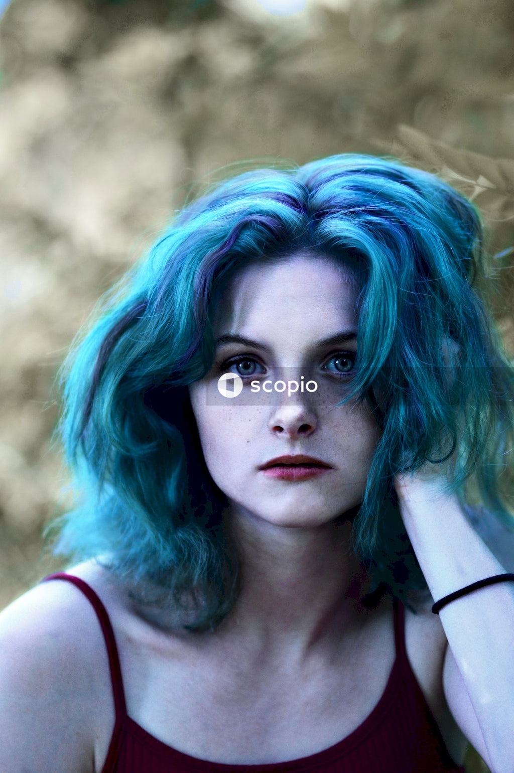Woman in black top and blue hair