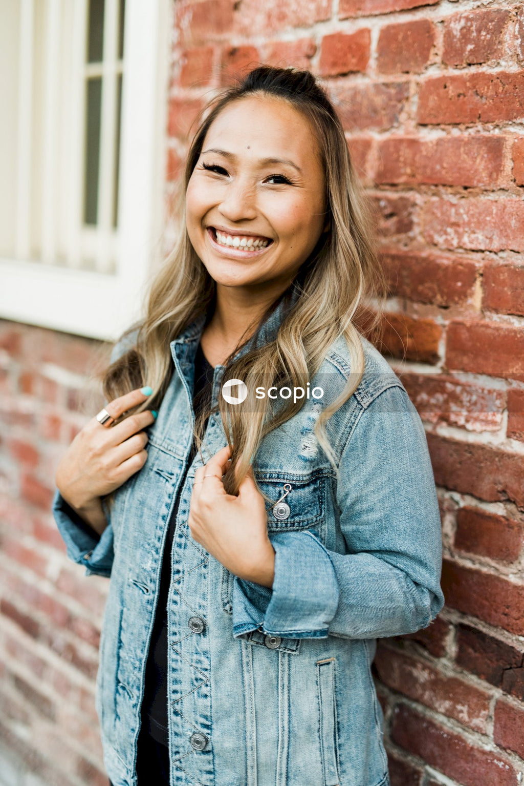 Smiling woman in blue denim jacket
