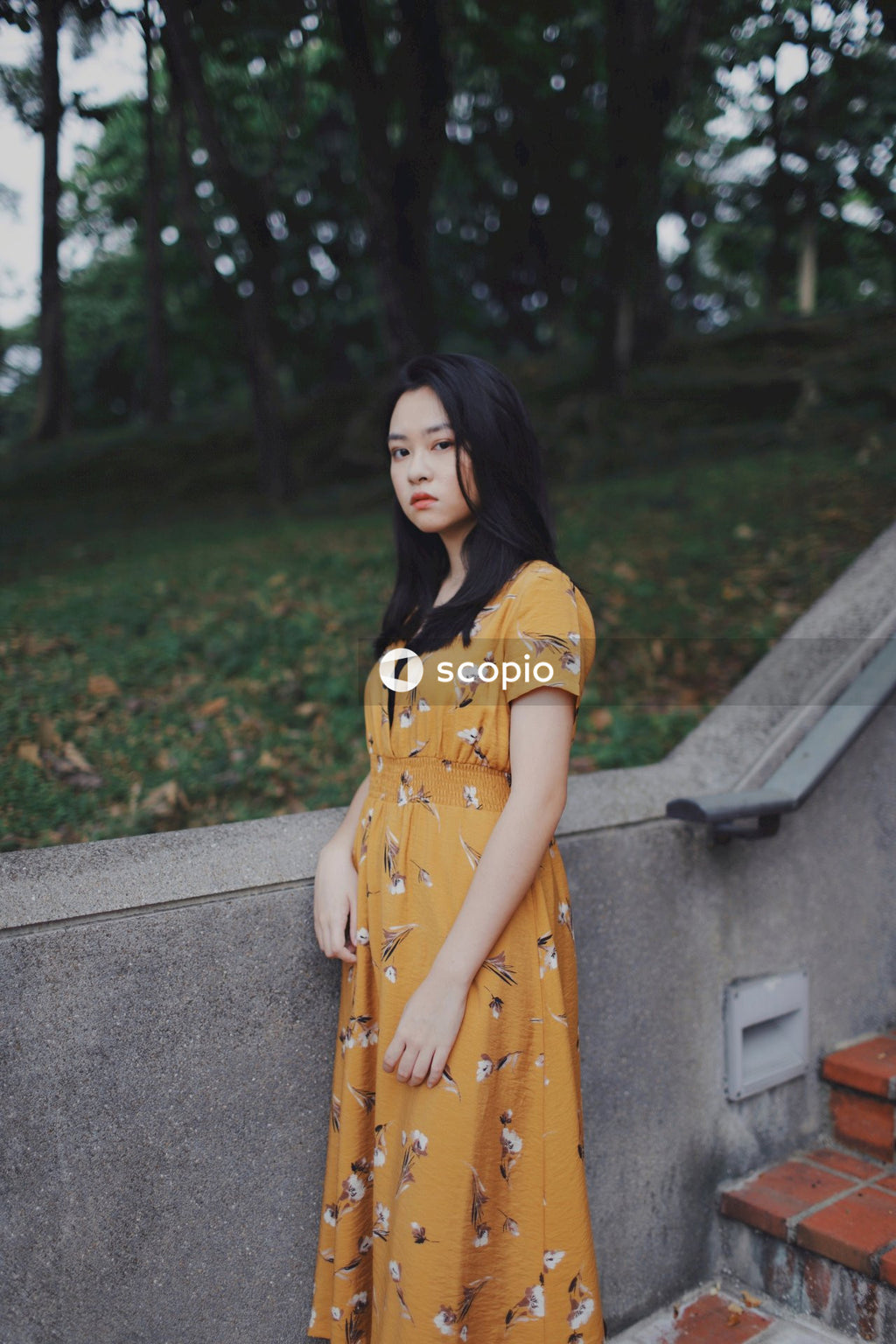 Woman wearing long orange dress standing in nature