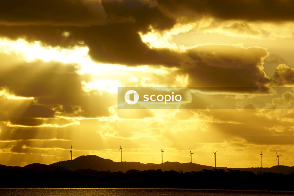 Silhouette of mountain under cloudy sky during sunset