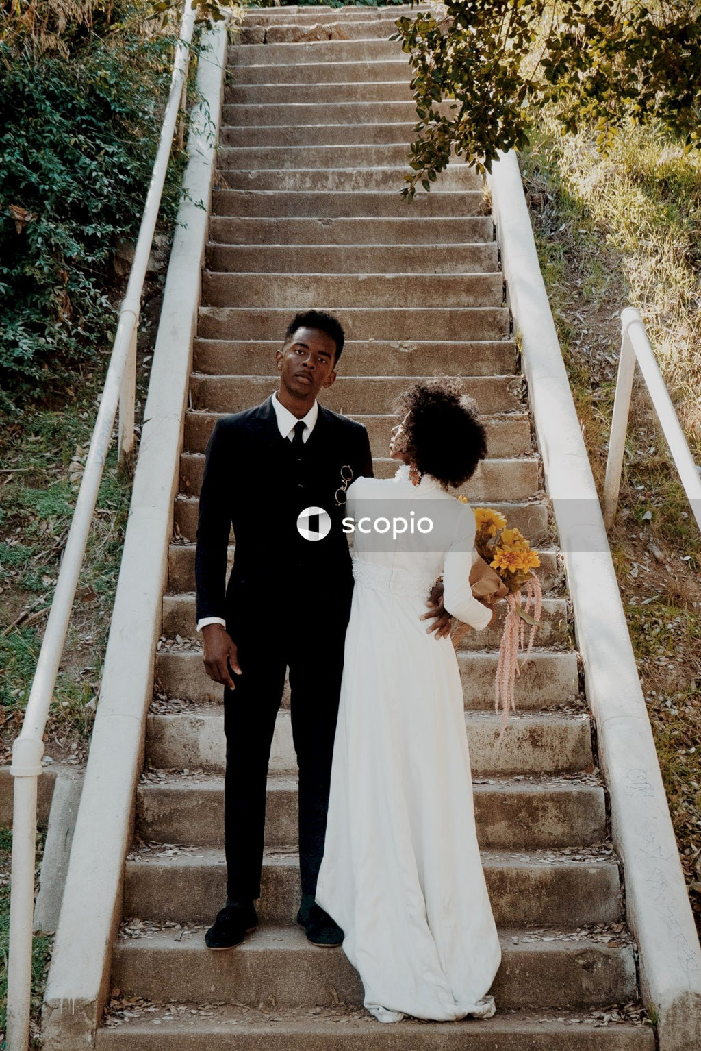 Bride and groom standing on steps
