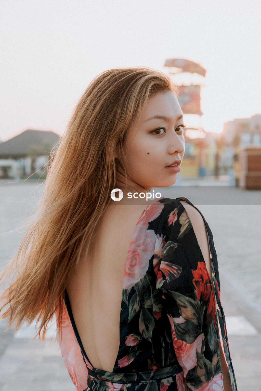 Woman in black red and green floral shirt