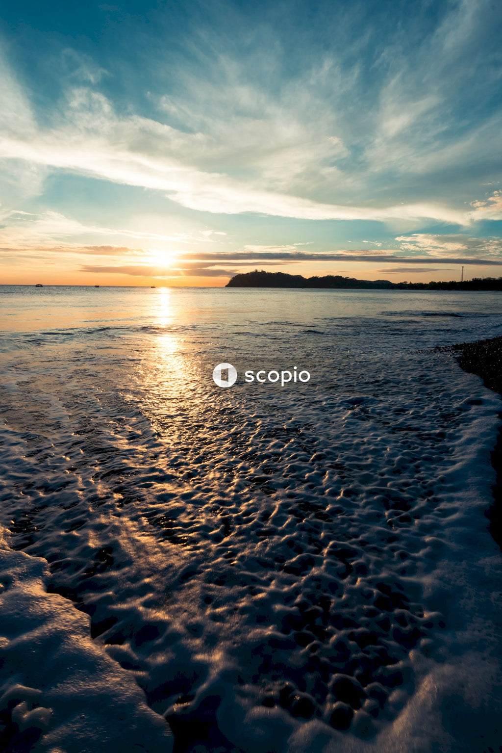 Sea waves crashing on shore during sunset