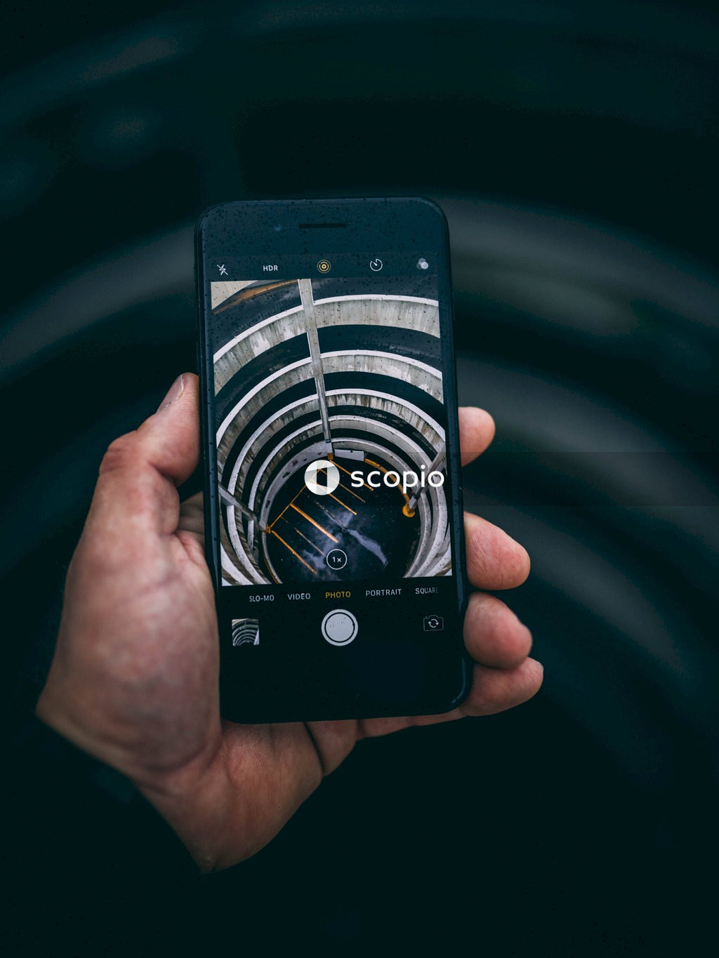 Hand Holding Phone With Picture of Round Parking