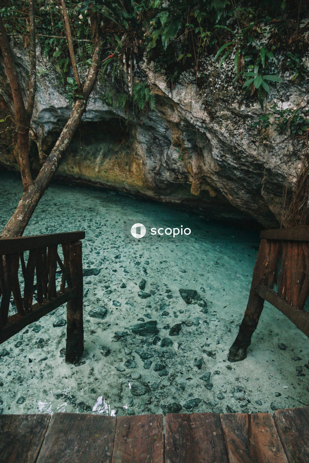 Brown wooden bridge over blue body of water