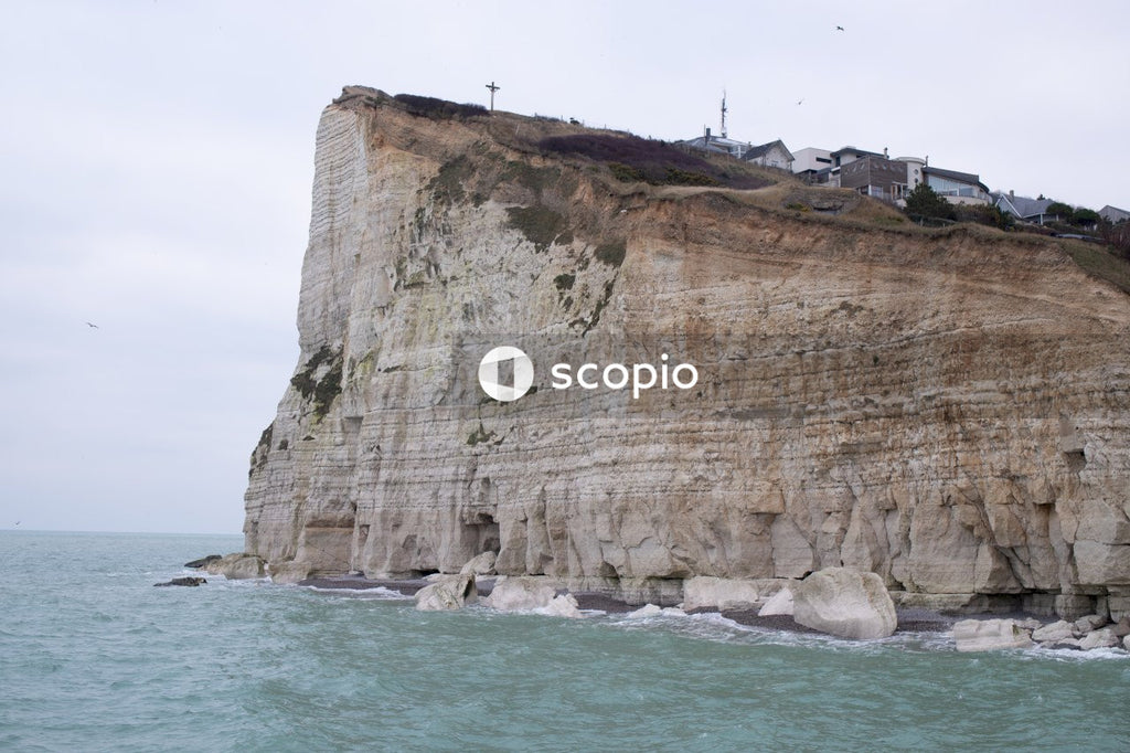 Brown rock formation near body of water