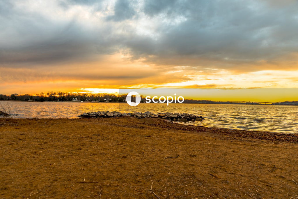 Sea waves crashing on shore during sunset