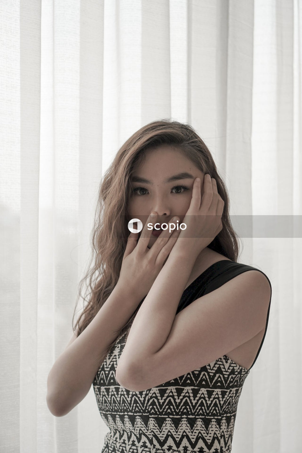 Portrait of woman with her hands on her face