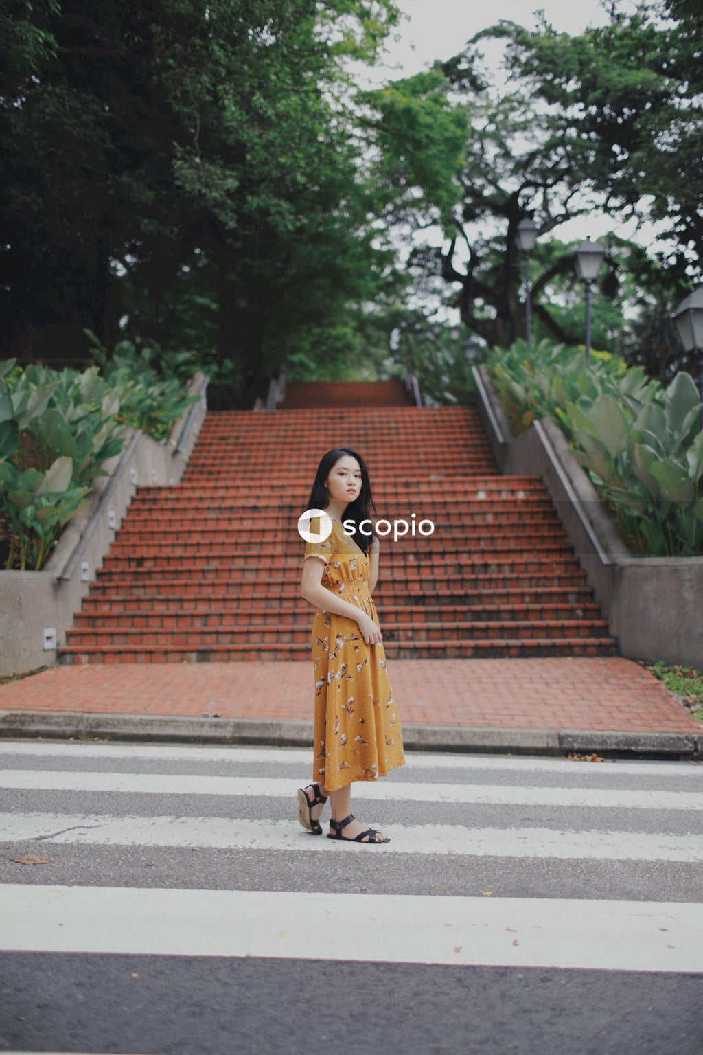 Woman in yellow dress standing on path