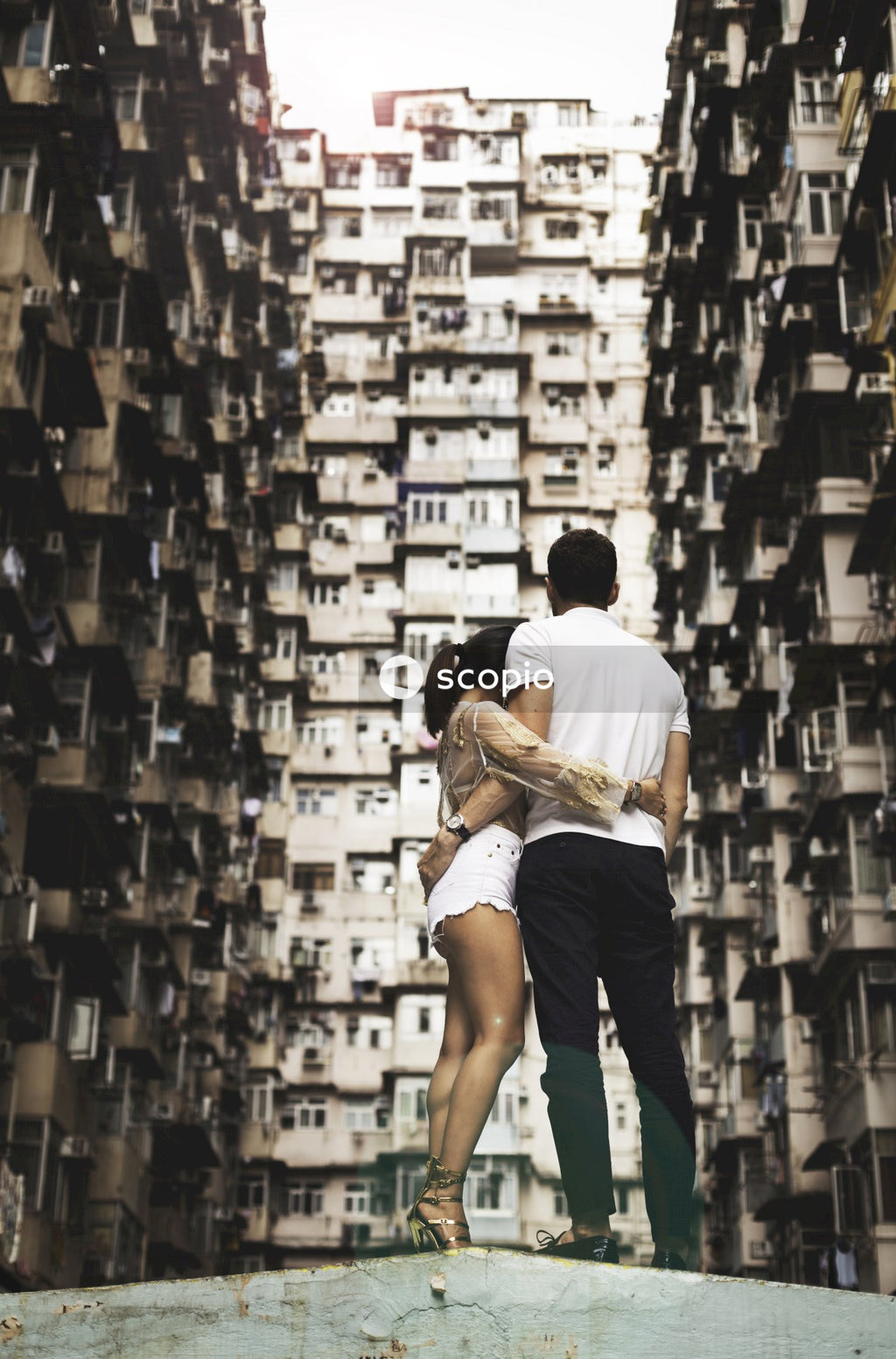 Couple standing near high rise buildings