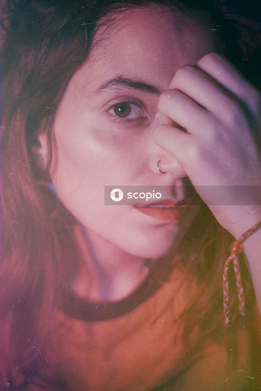 Portrait of Hispanic woman touching her forehead