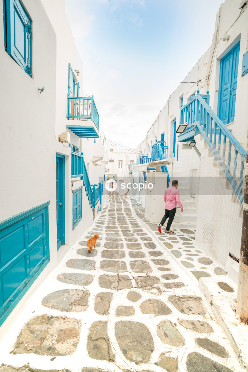 Mature man walking in a blue and white alley