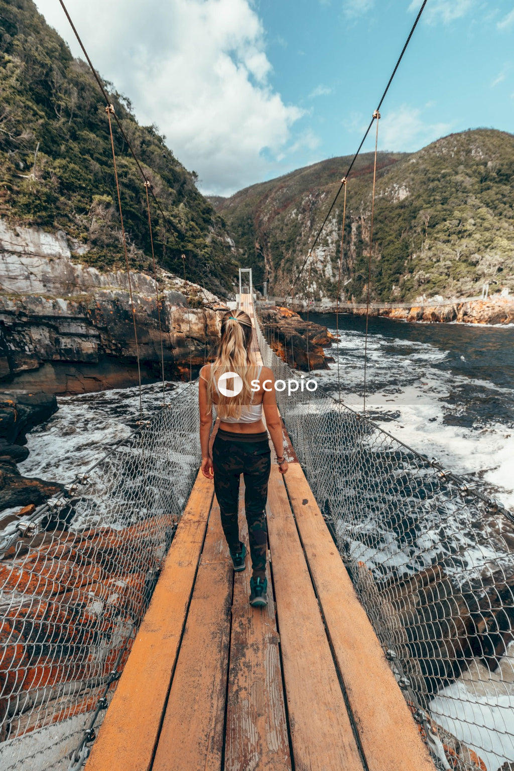 Woman walking on bridge