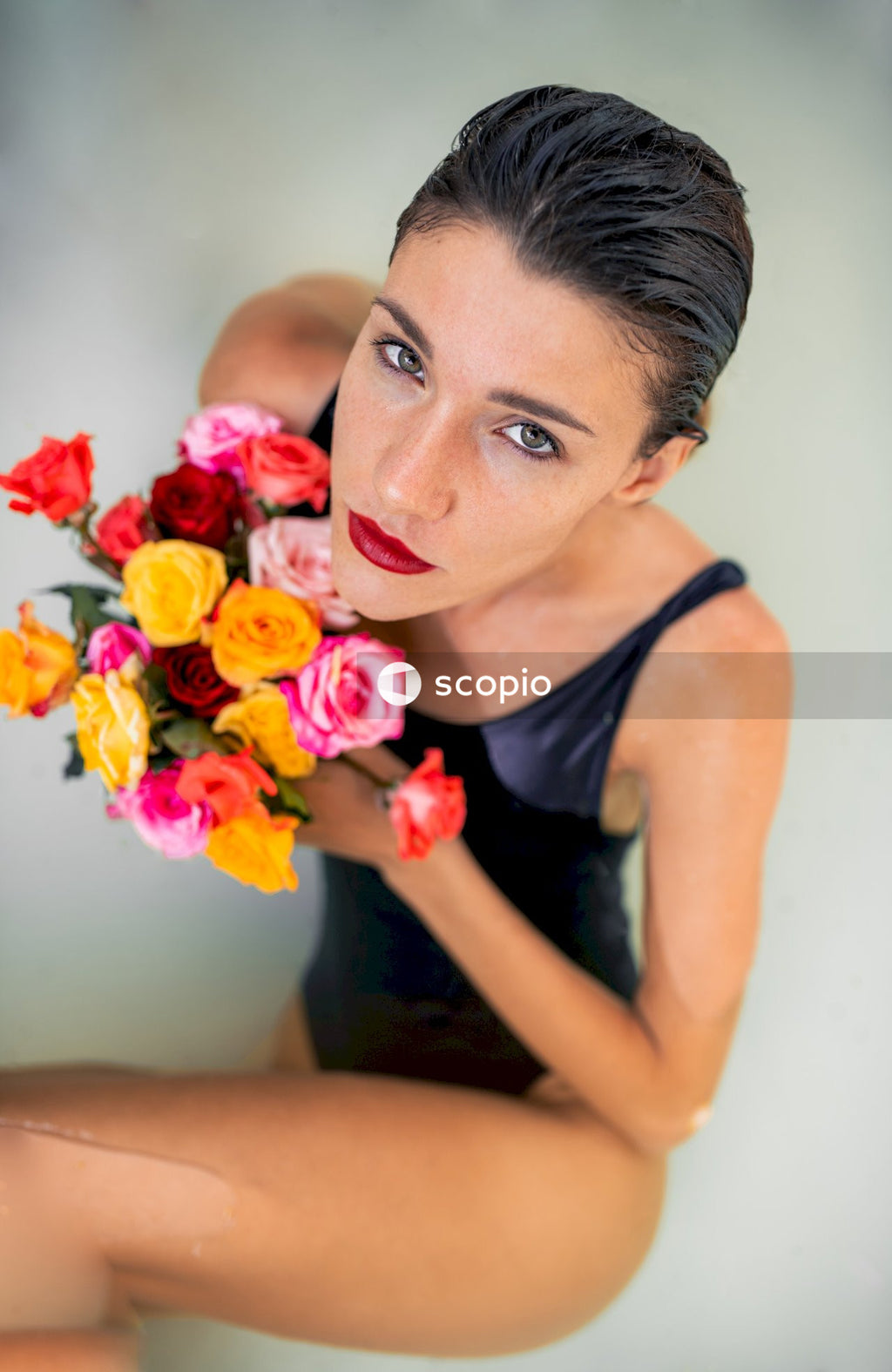 Selective focus photography of woman holding flowers