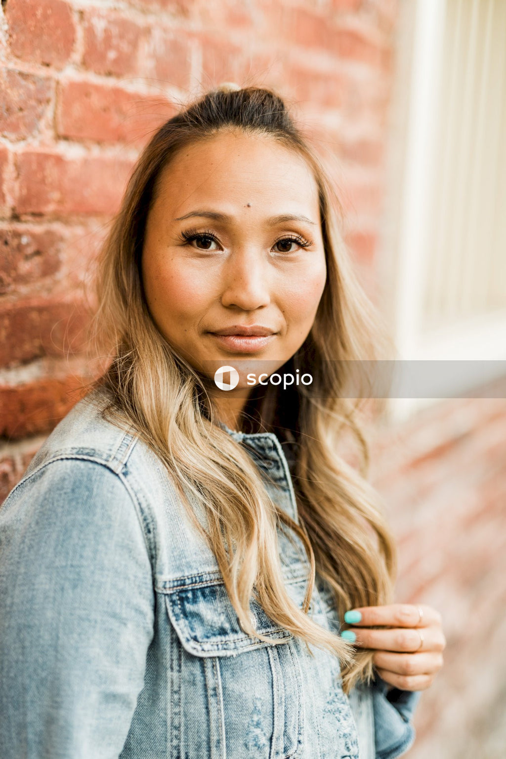 Woman in blue denim jacket smiling