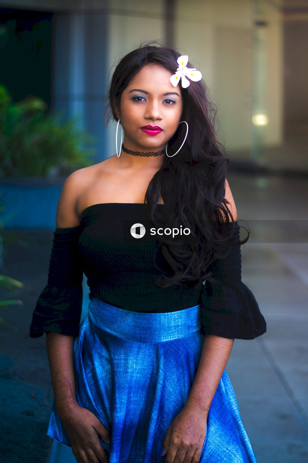 Woman in black off shoulder shirt and blue denim skirt
