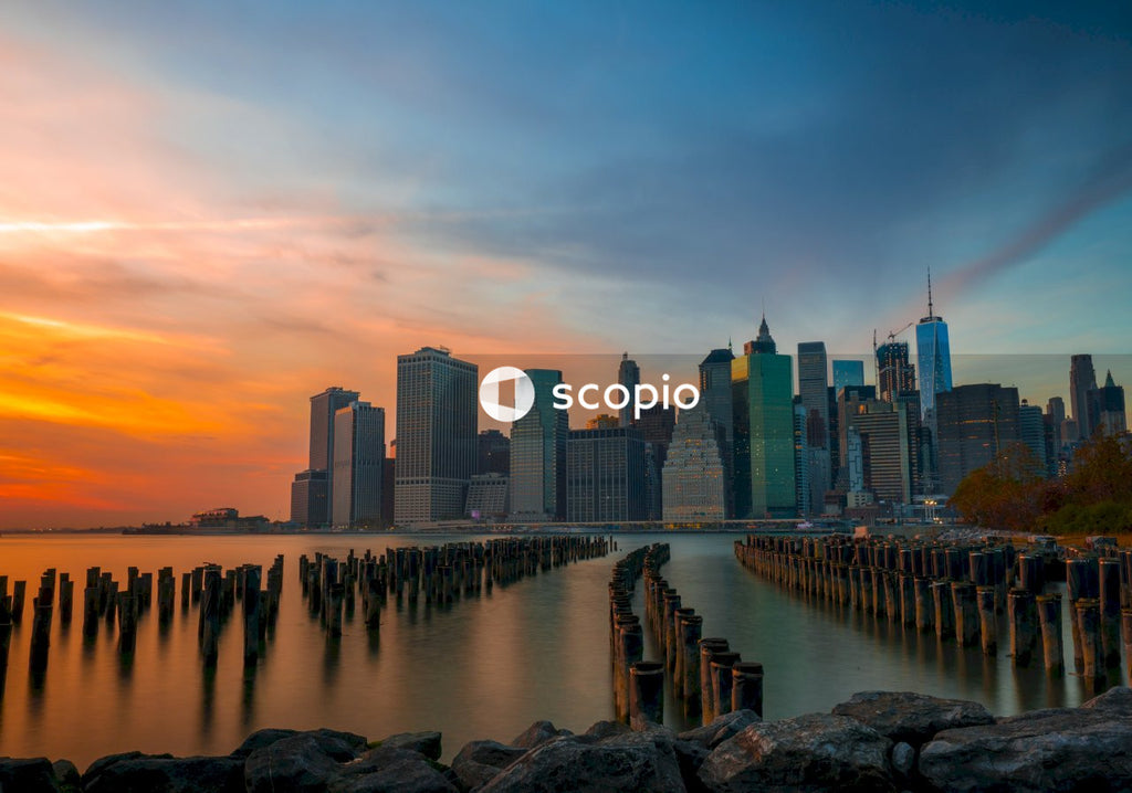 City skyline across body of water during sunset