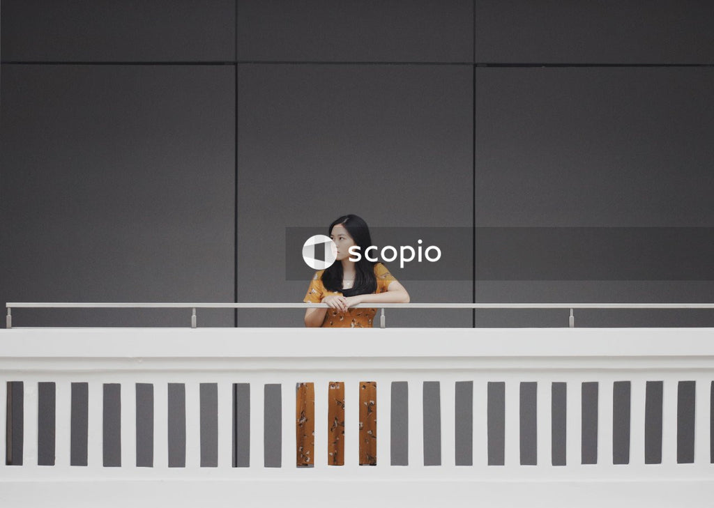 Woman in orange dress standing on balcony