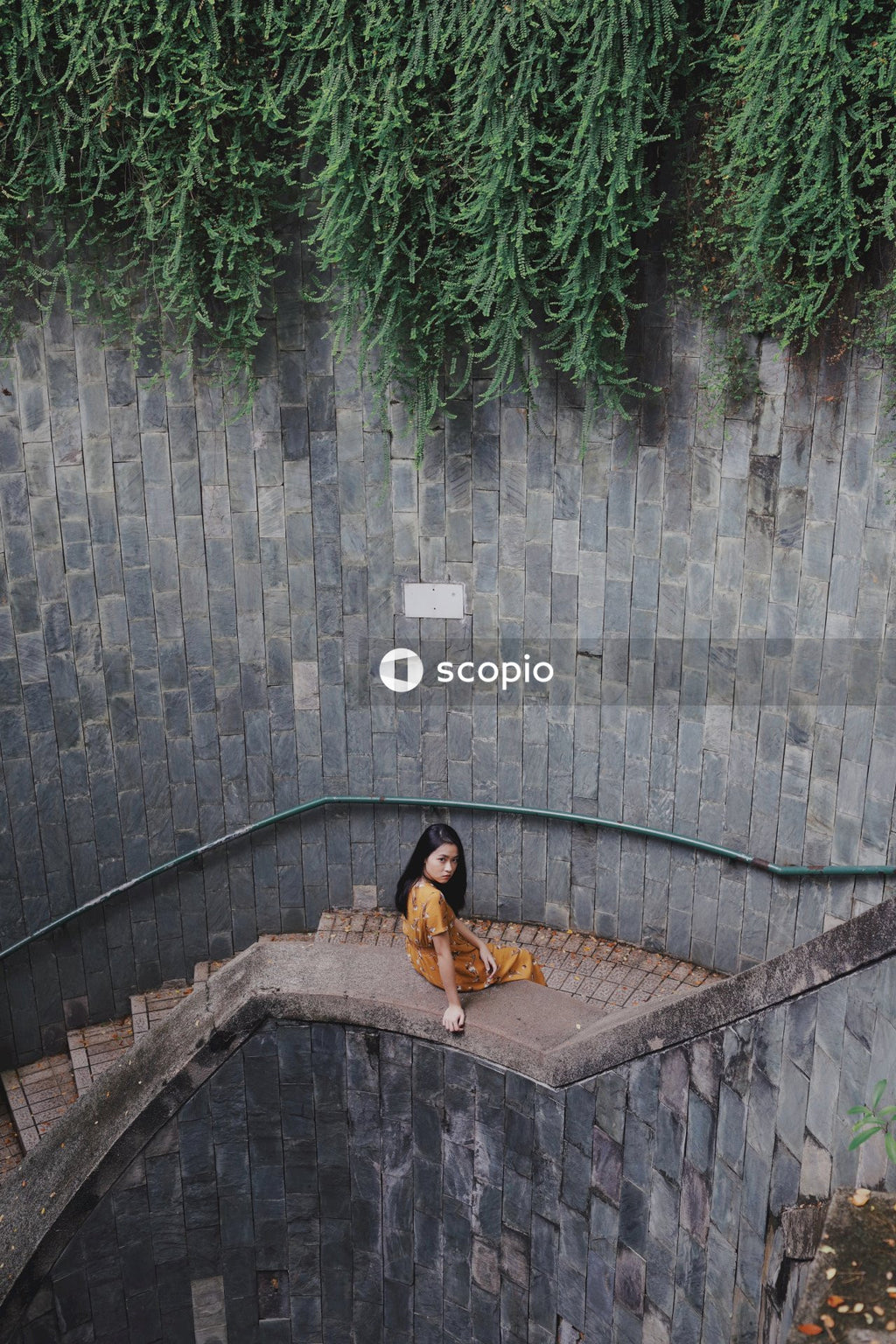 Woman in long orange dress on stairs