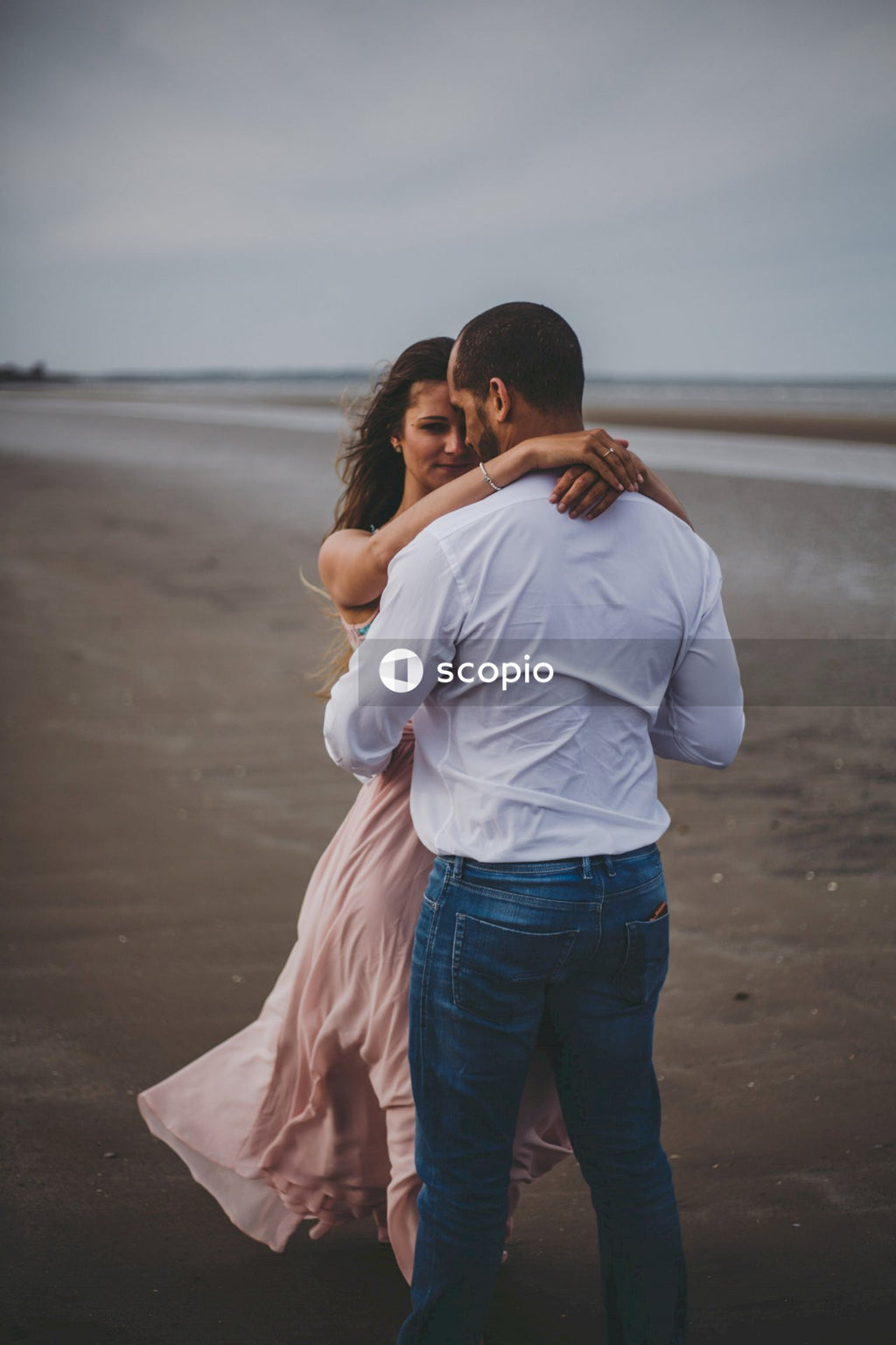 Man in white shirt kissing woman in white shirt
