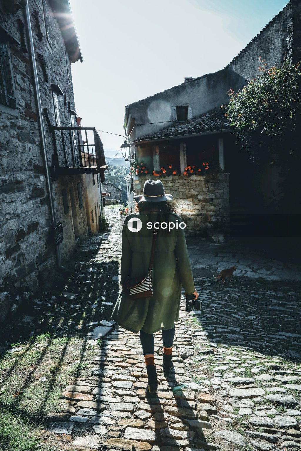 Woman in brown coat walking on street