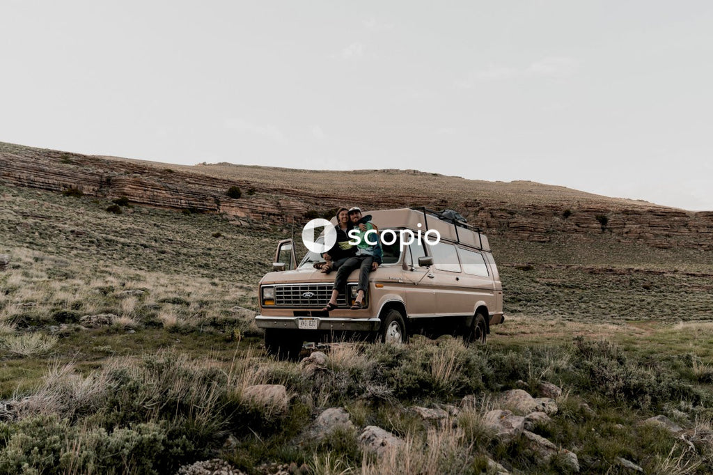 Couple sitting on vehicle's hood