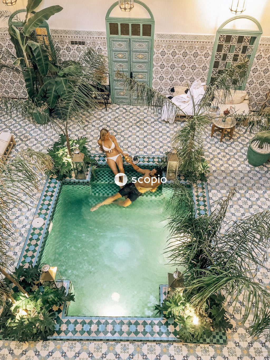 Couple relaxing in courtyard pool