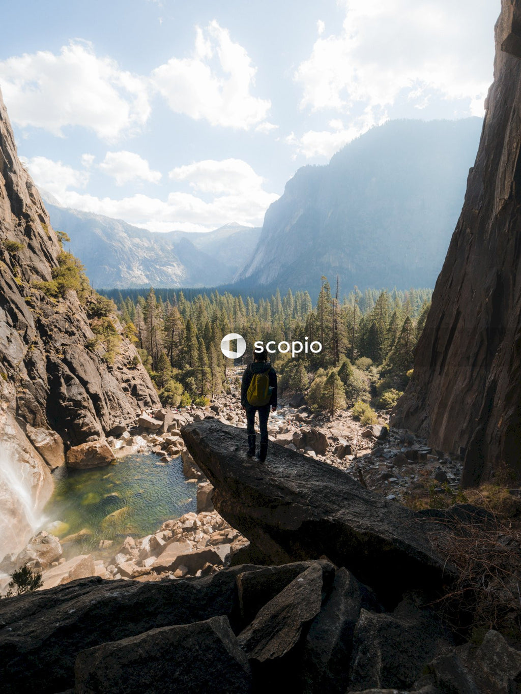 Woman standing at the edge of rock mountain