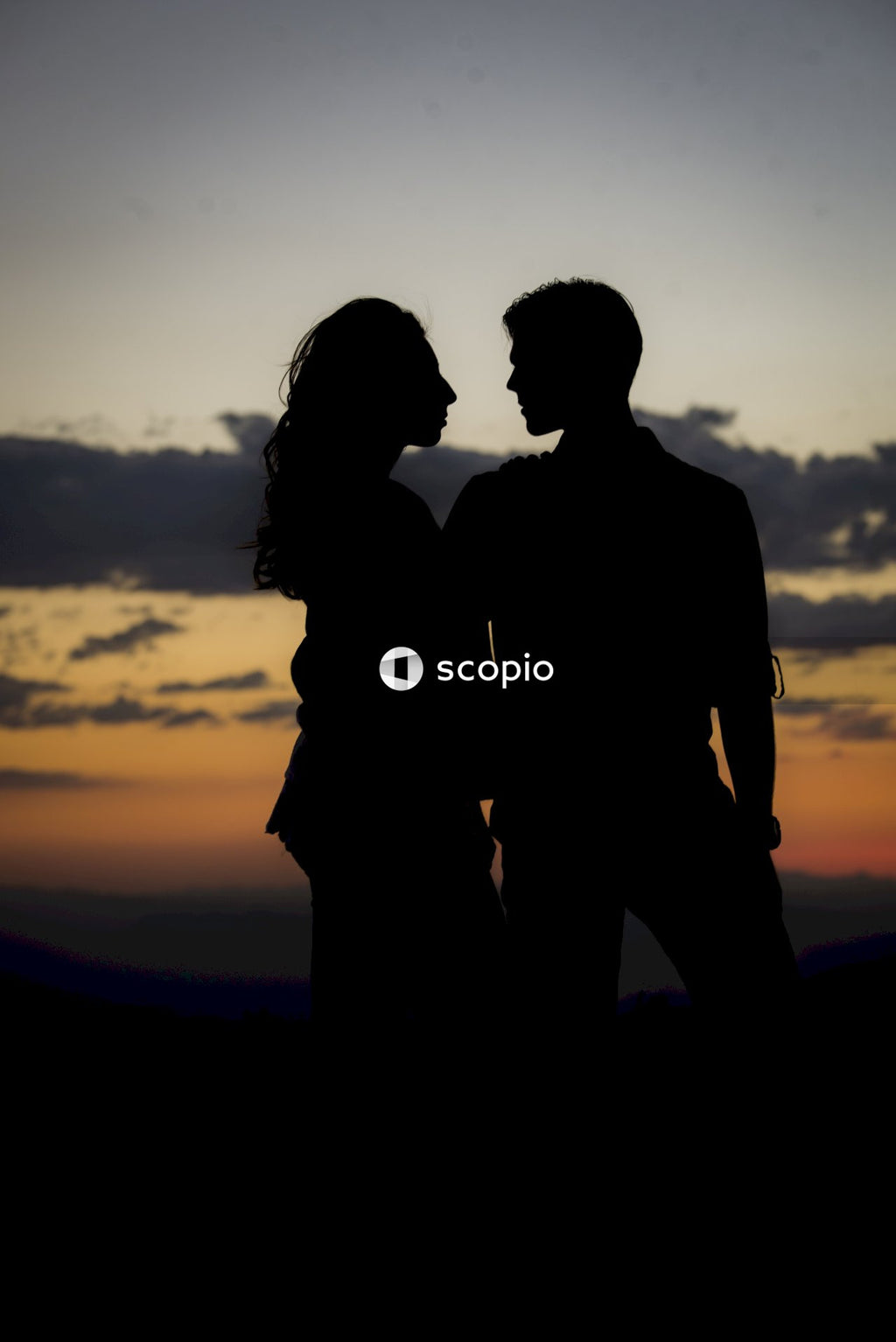 Silhouette of man and woman standing during sunset