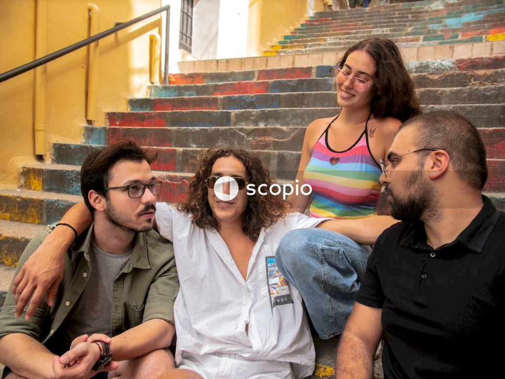 Four friends sitting on stairs and laughing