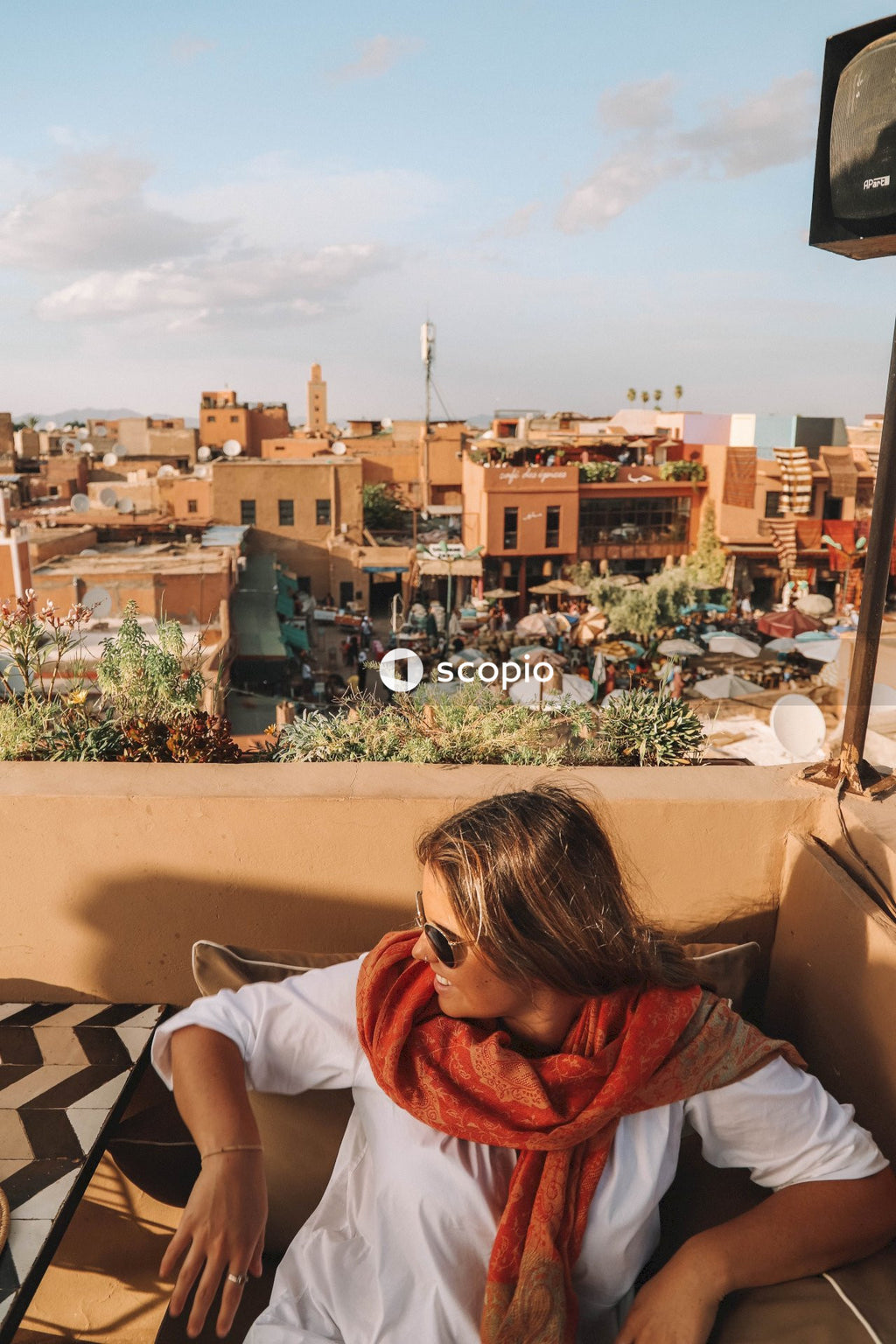 Woman with sunglasses sitting in terrace