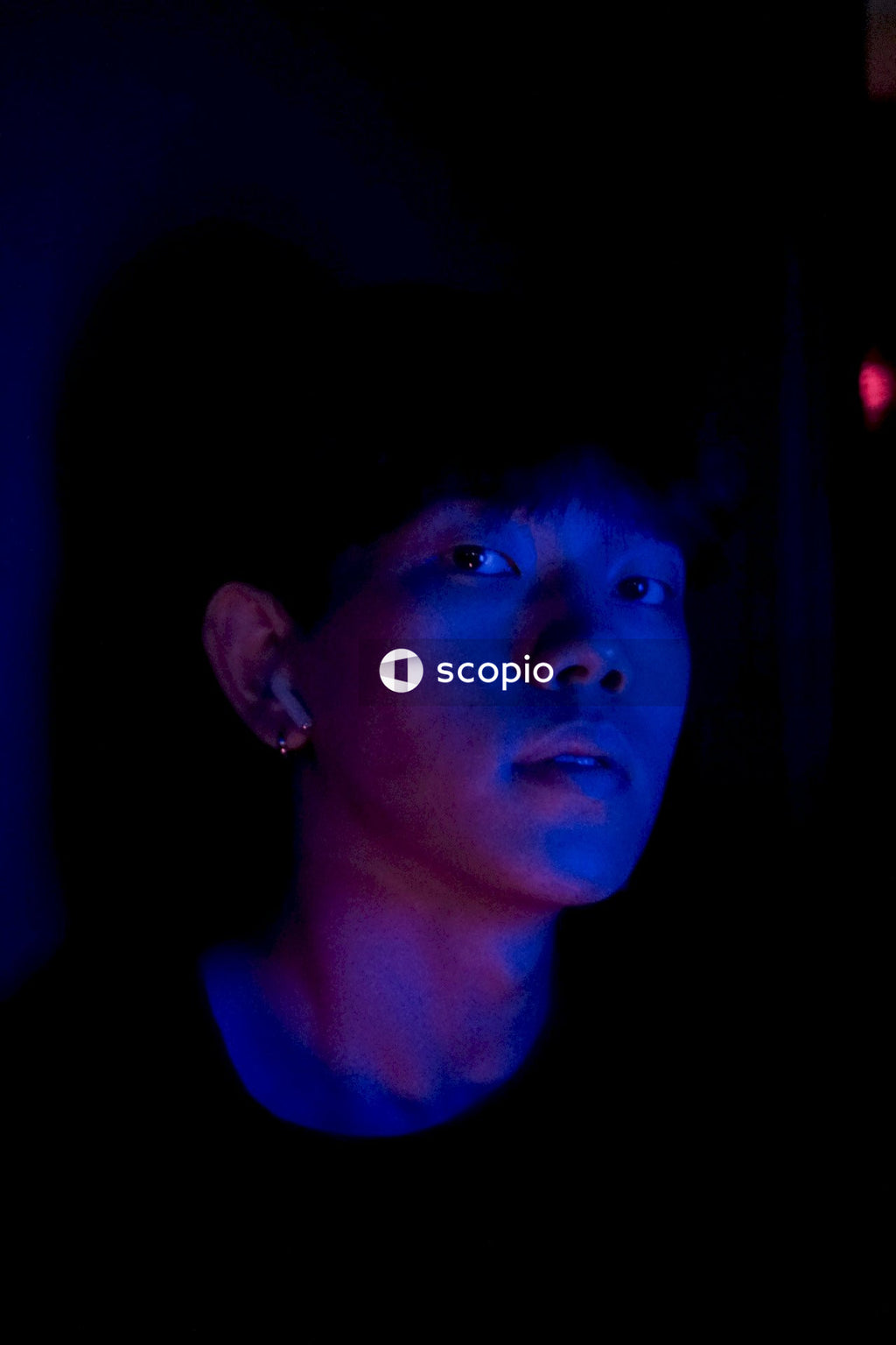 Portrait photoshoot of man standing in blue light