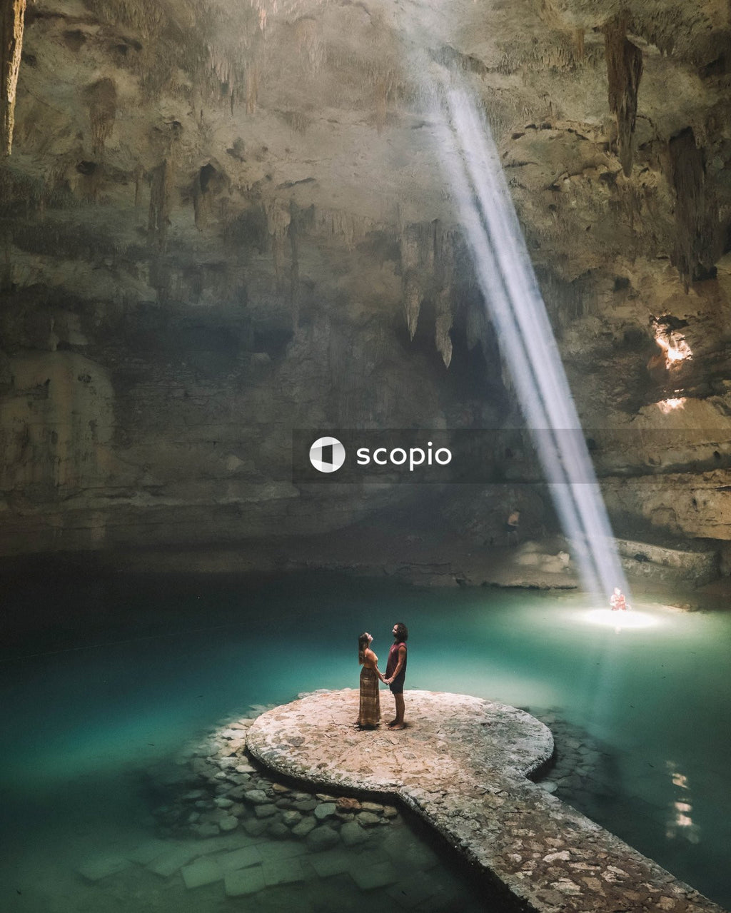 Couple standing in cave filled with water
