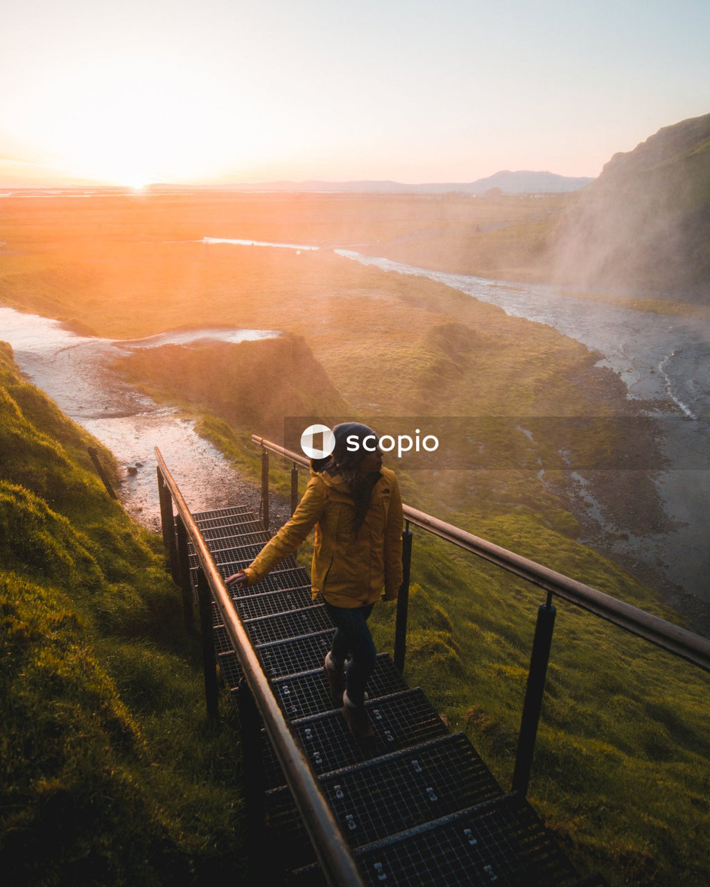 Woman climbing on stairs facing mountains