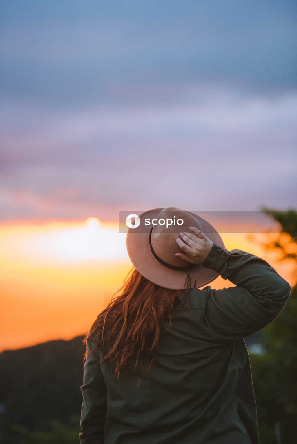 Woman in brown hat and black jacket