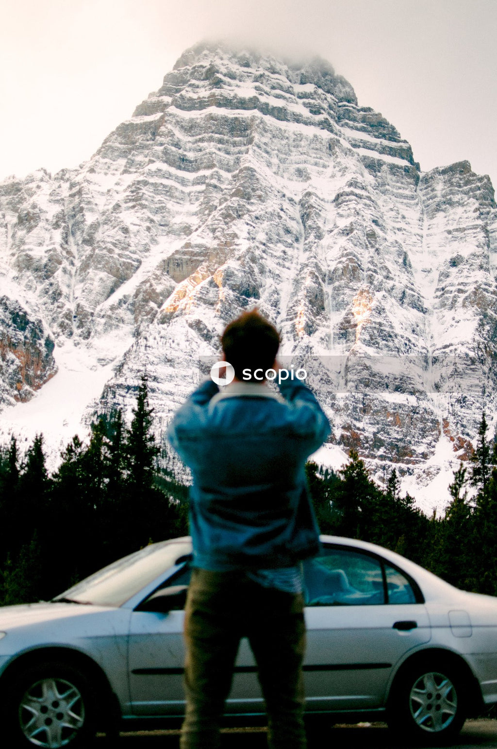 Man standing near gray coupe