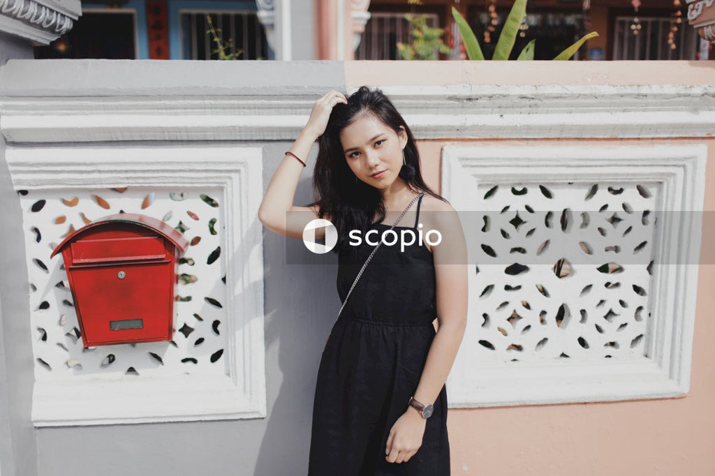 Woman on street posing near building