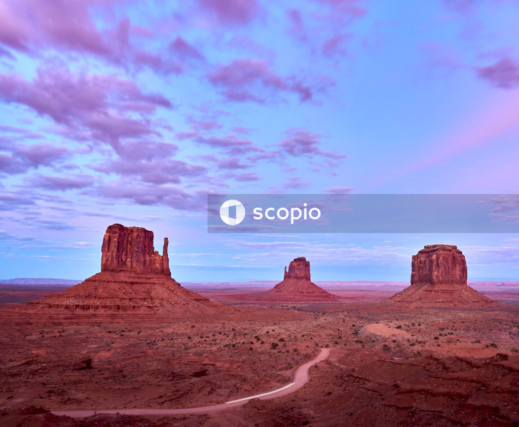 Brown rock formation under white clouds