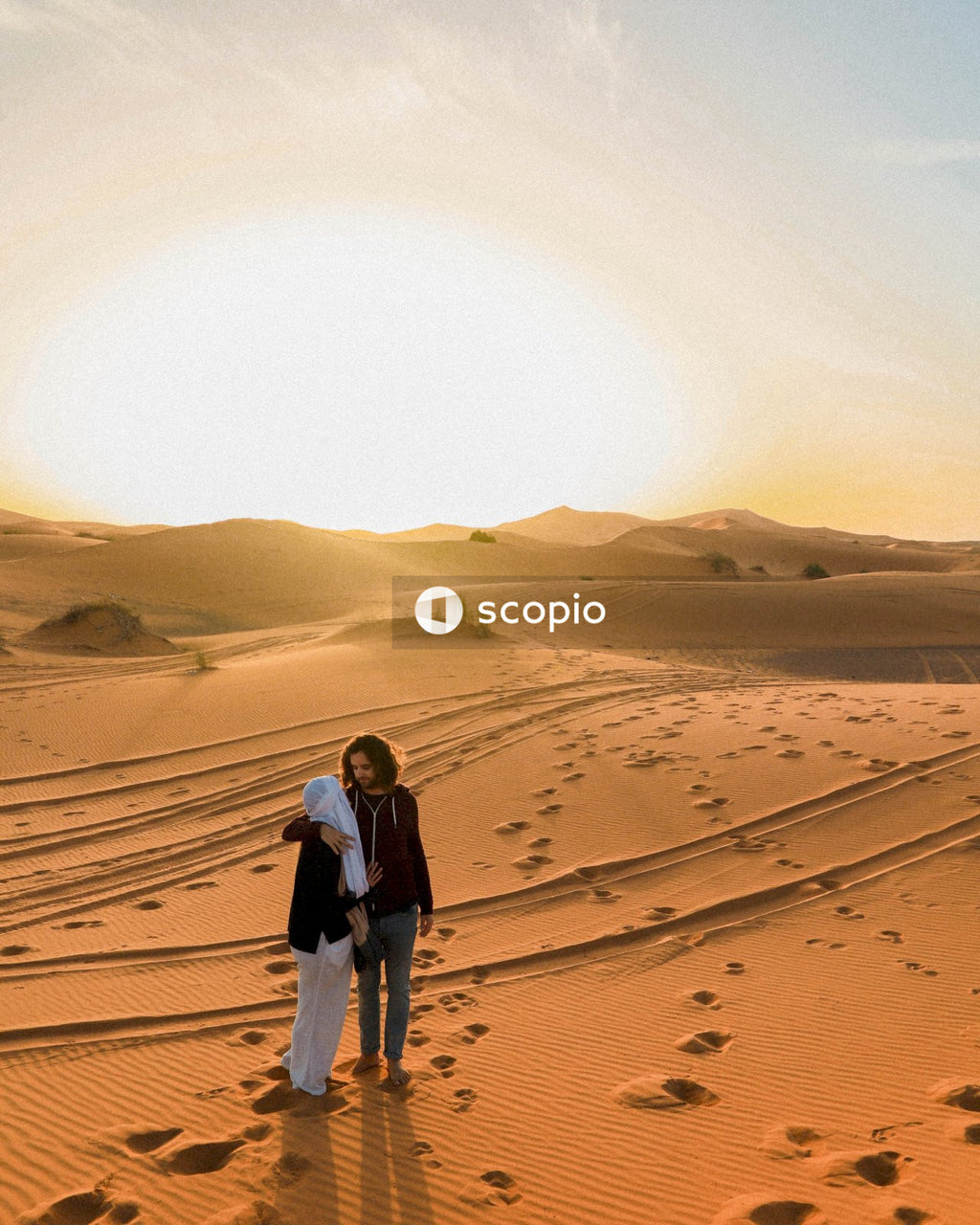 People hugging on desert