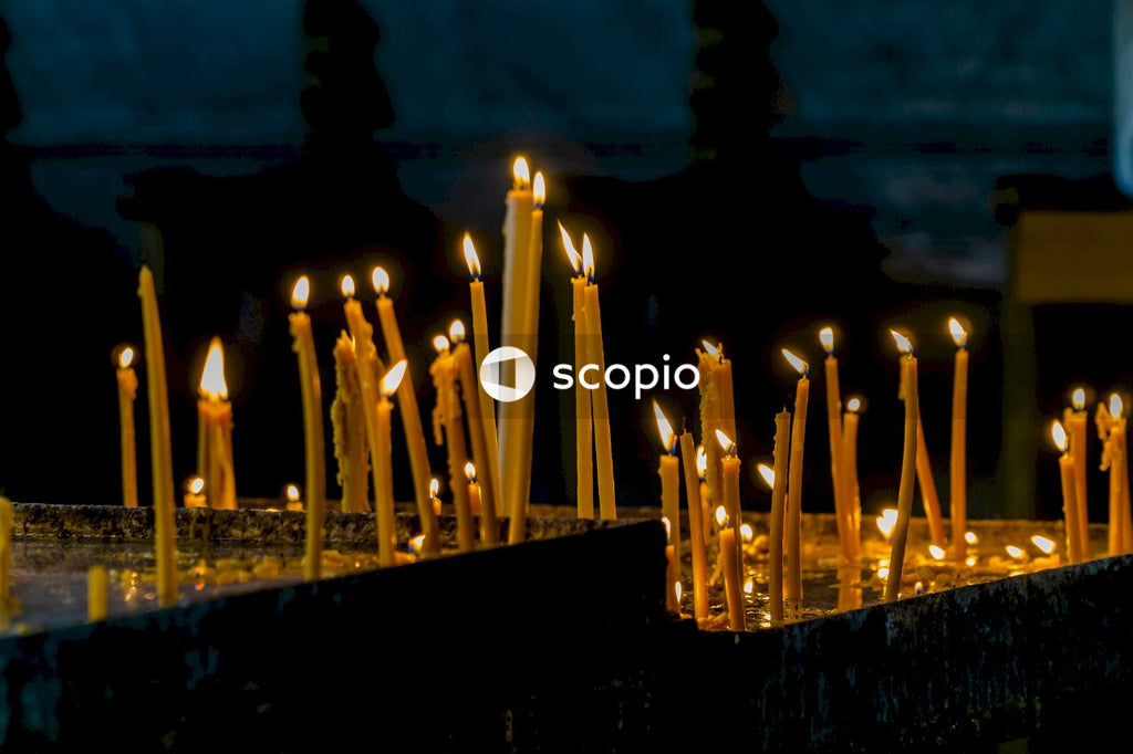 Lighted candles on black concrete wall