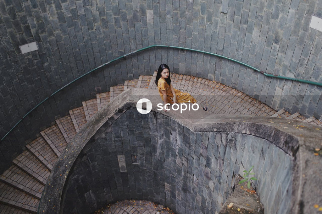 Woman in long orange dress on stairs