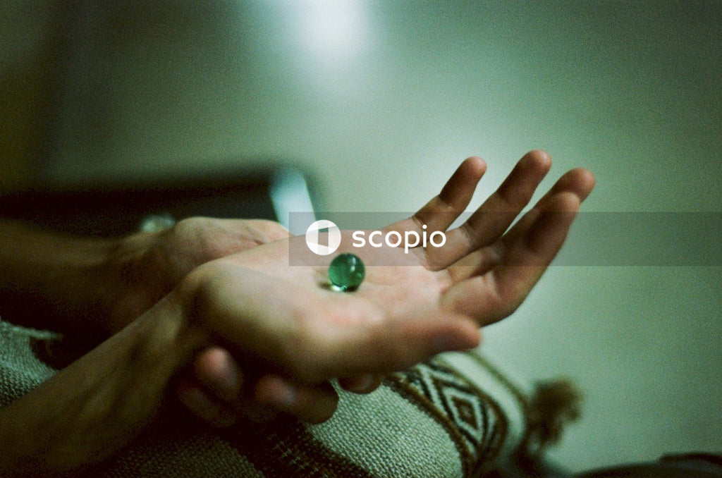 Green Round Ornament on Persons Hand