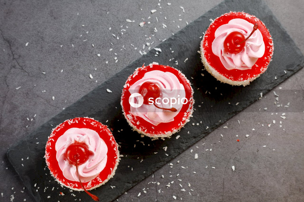 2 cupcakes with white icing on top