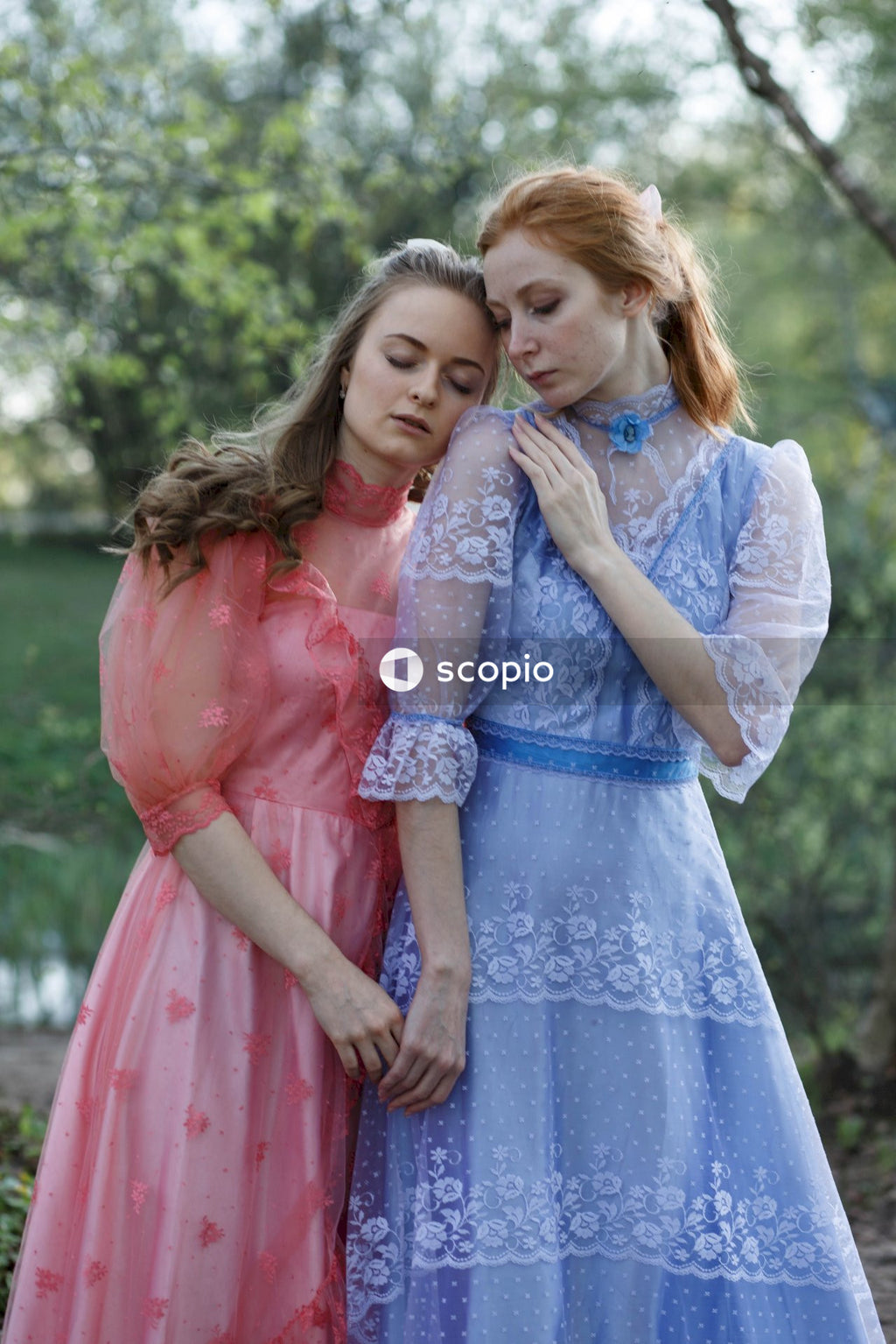 2 girls in blue dress hugging each other