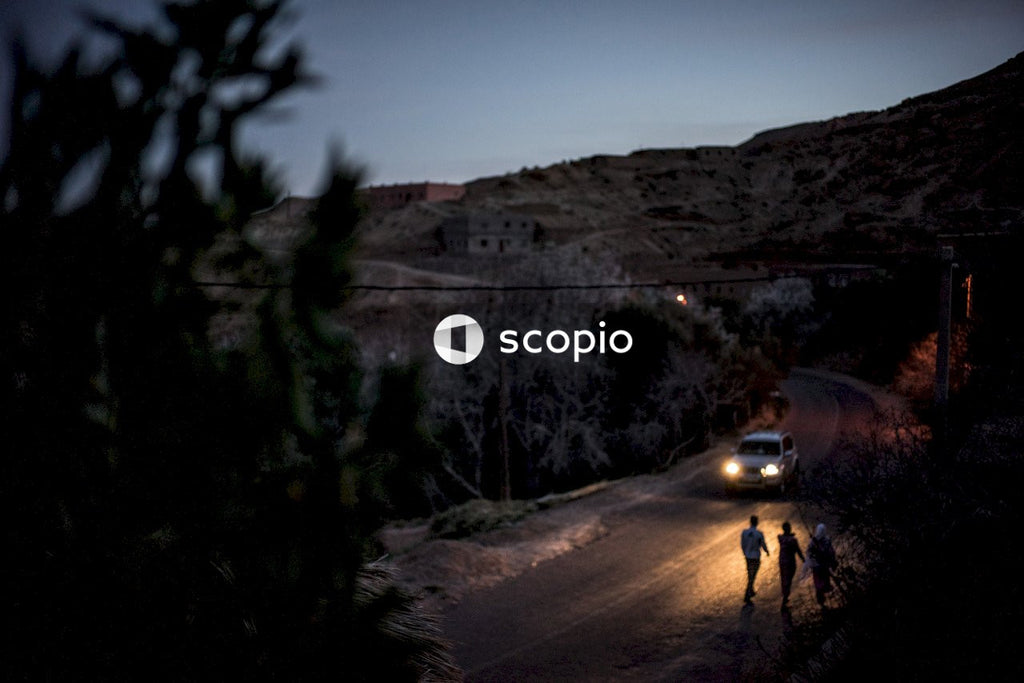 2 people walking on road near mountain