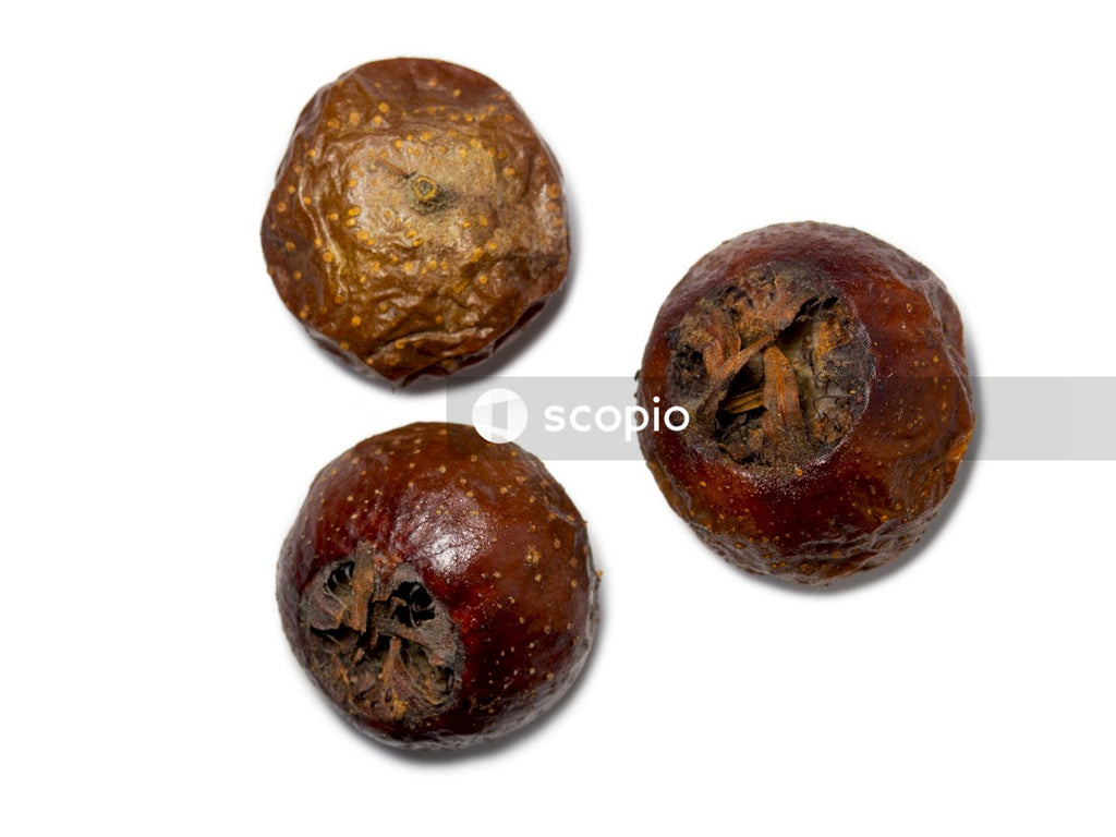 2 round brown fruit on white surface