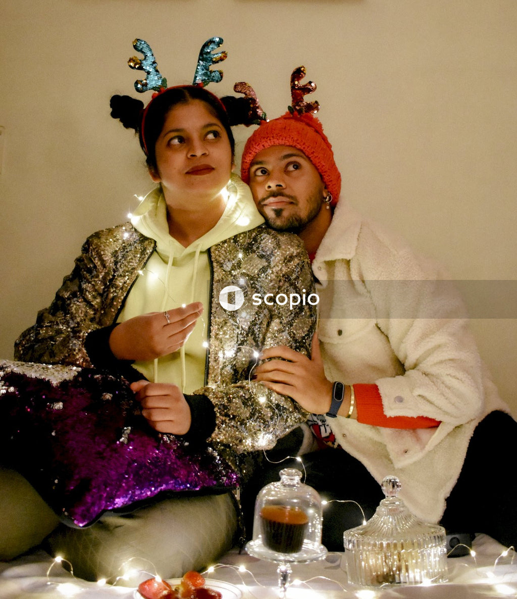 2 women in hijab sitting on couch