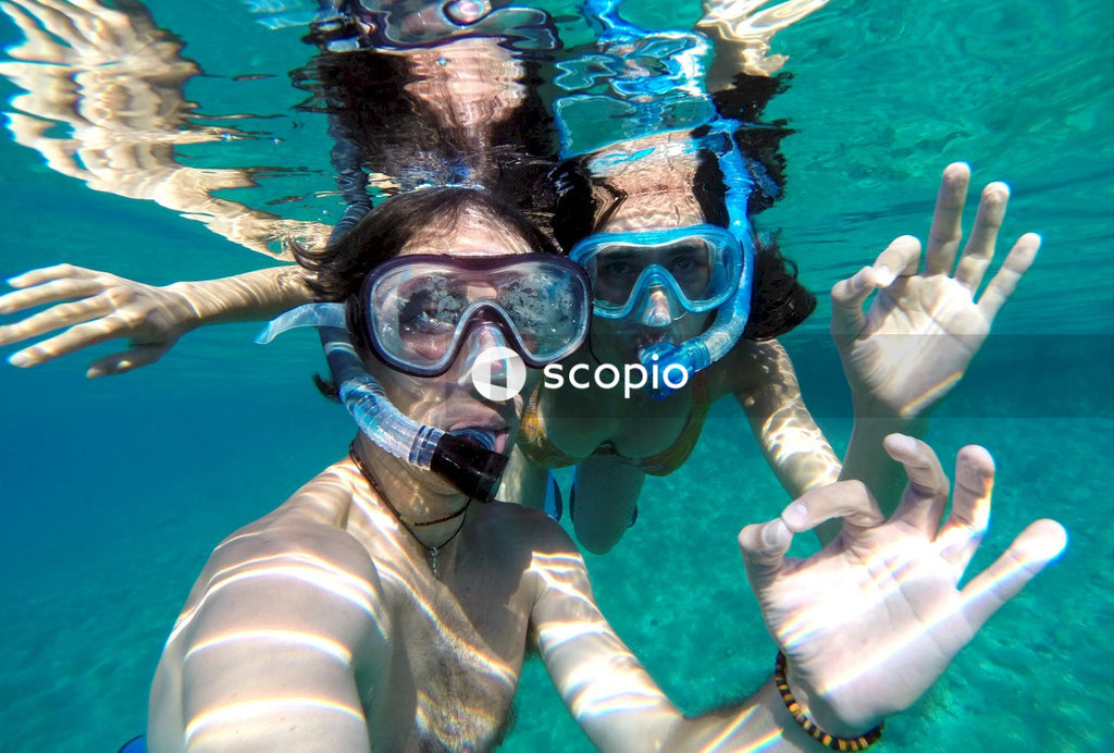 Underwater selfie of young couple snorkeling in swimming pool