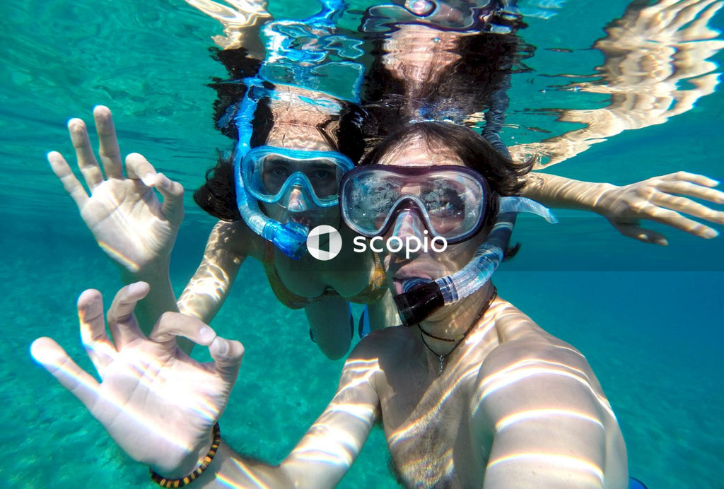 Underwater selfie of young couple snorkeling in swimming pool