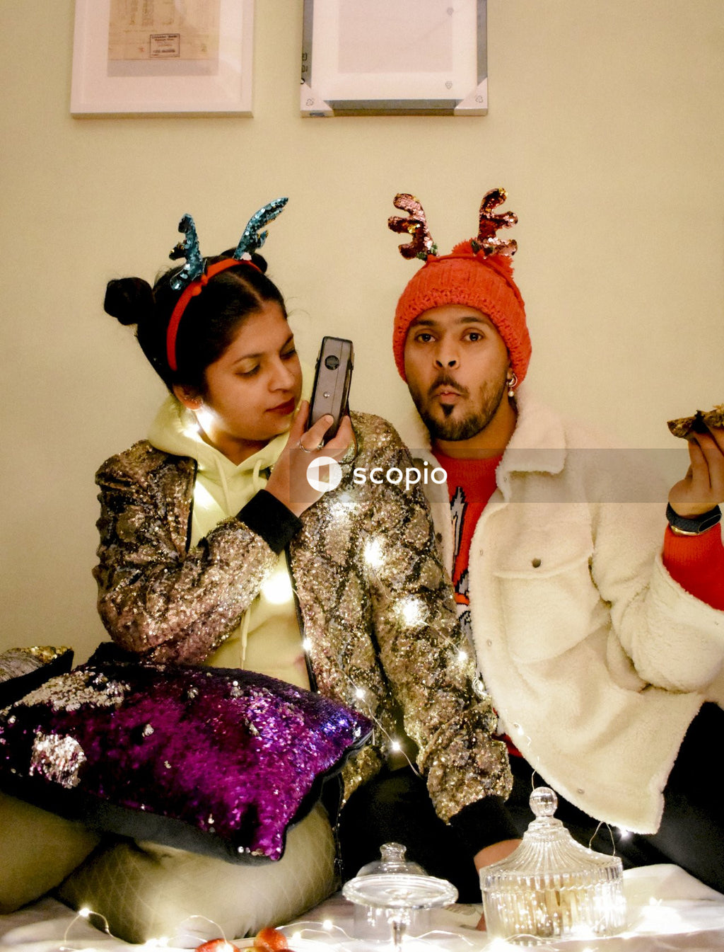 Man and woman eating cookie and taking selfie